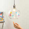Hand-blown colorful glass pendant lights with unique internal decorations for the kitchen island.