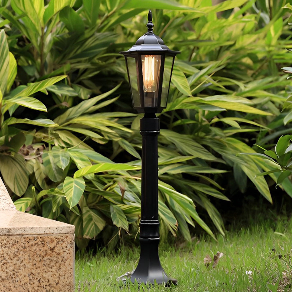 Hexagon path light providing soft illumination along a stylish stone walkway.