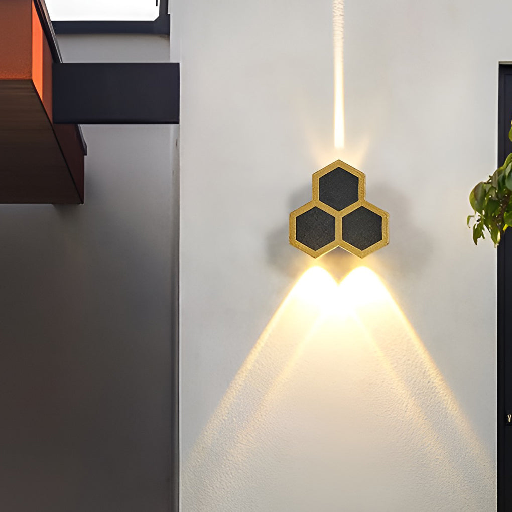 Honeycomb LED lights wall illuminating a minimalist outdoor entrance with focused glow.