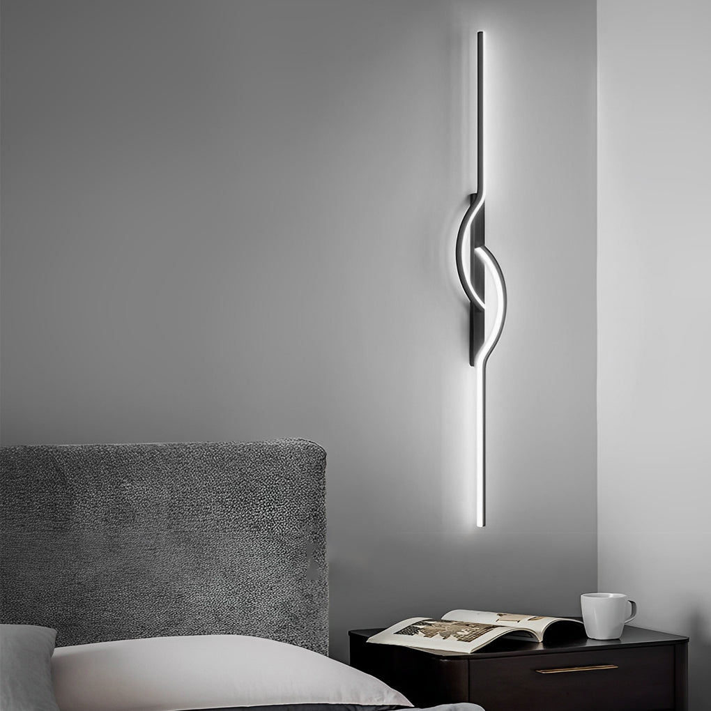 Horizontal modern linear wall sconce providing soft accent lighting above a bed.
