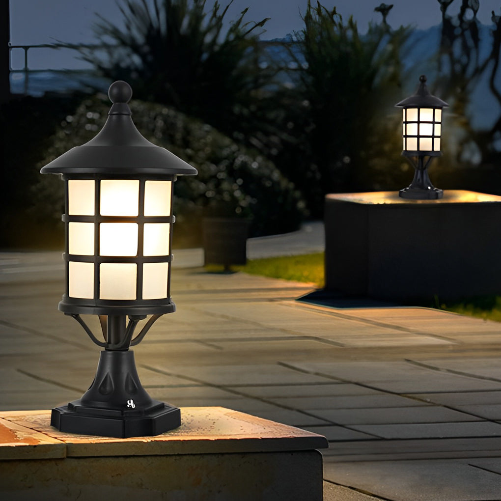 House pillar lights with a close-up of their glowing glass panels at dusk.