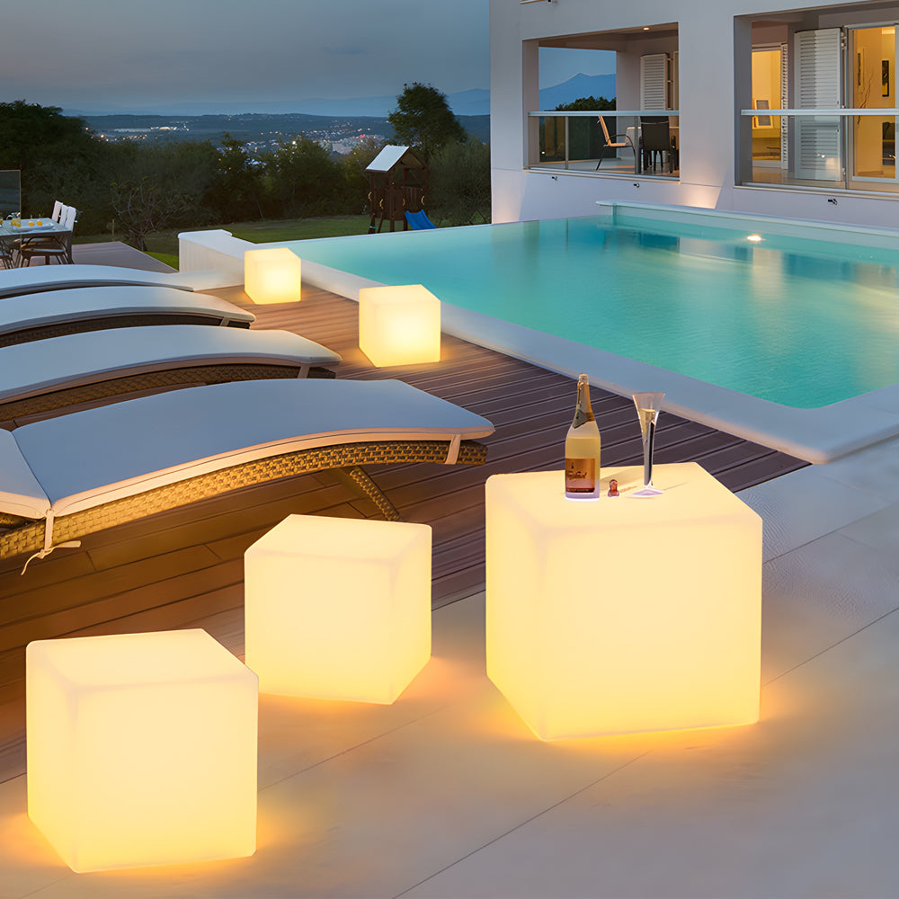 Ice cube LED lights arranged as modern tables, enhancing an outdoor patio ambiance.