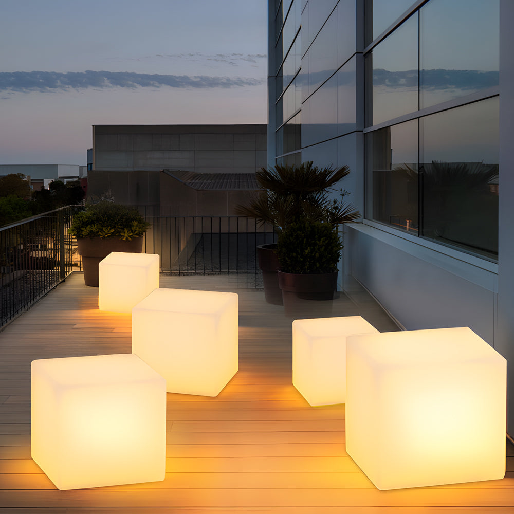 Ice cube LED lights with a soft glow, placed beside sun loungers by the pool.