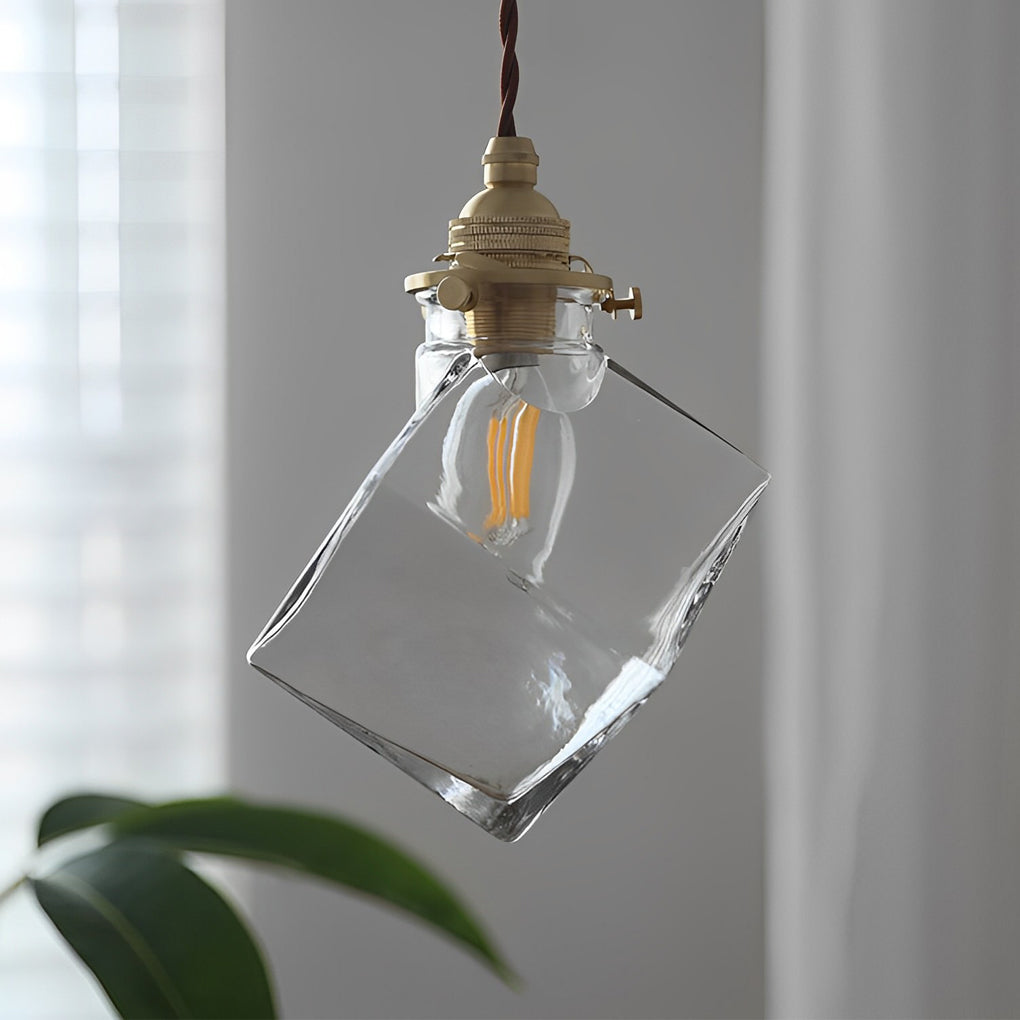 Ice cube pendant light with clear glass shade and brass socket detail.