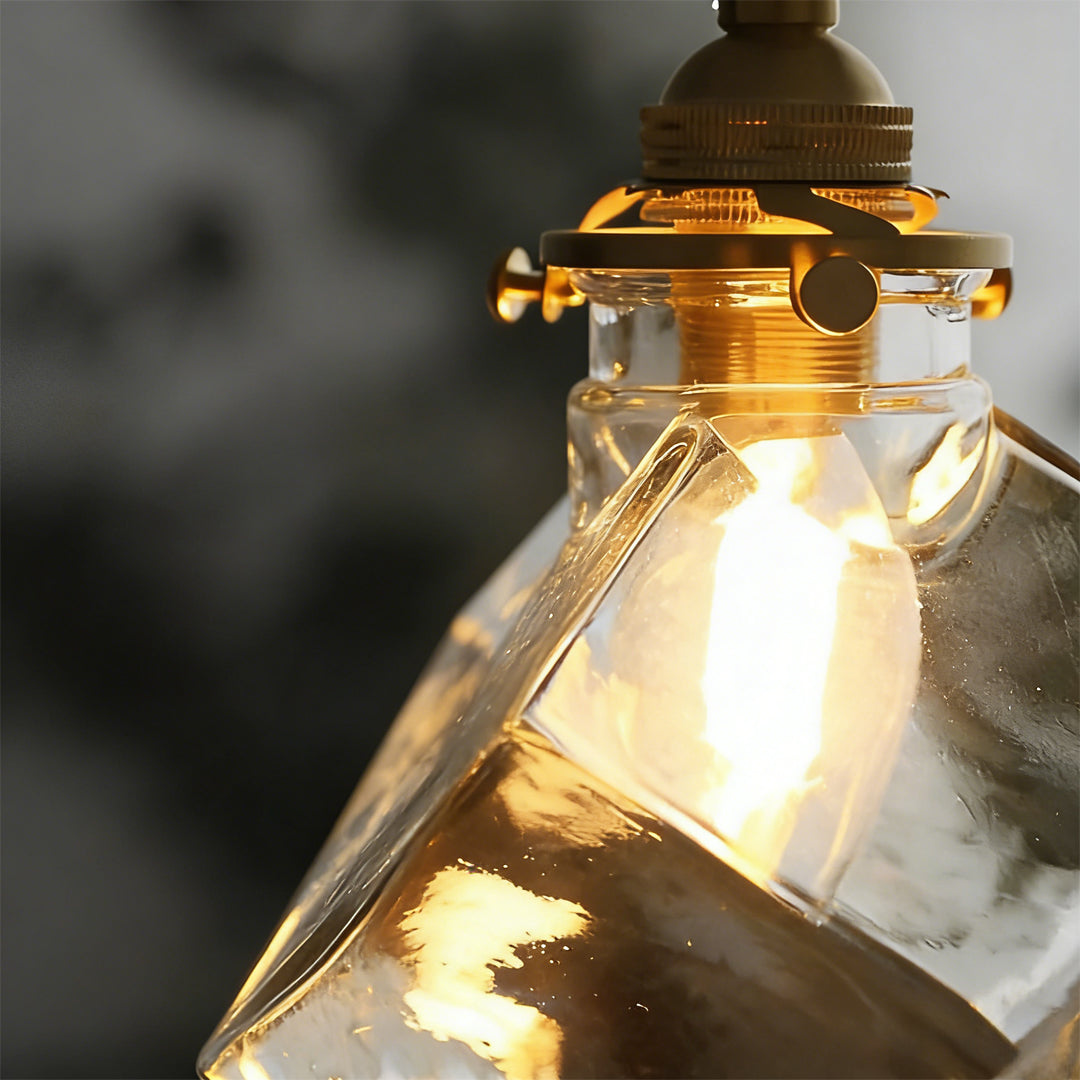 Ice cube pendant light illuminated, highlighting textured glass surface.