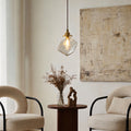 Ice cube pendant light hanging above armchairs in a minimalist living room.