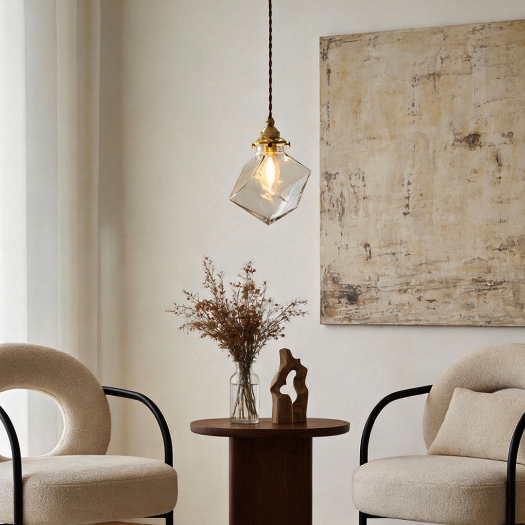 Ice cube pendant light hanging above armchairs in a minimalist living room.