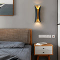 Indoor up down wall lights installed beside a modern bedroom bed with warm ambient lighting.