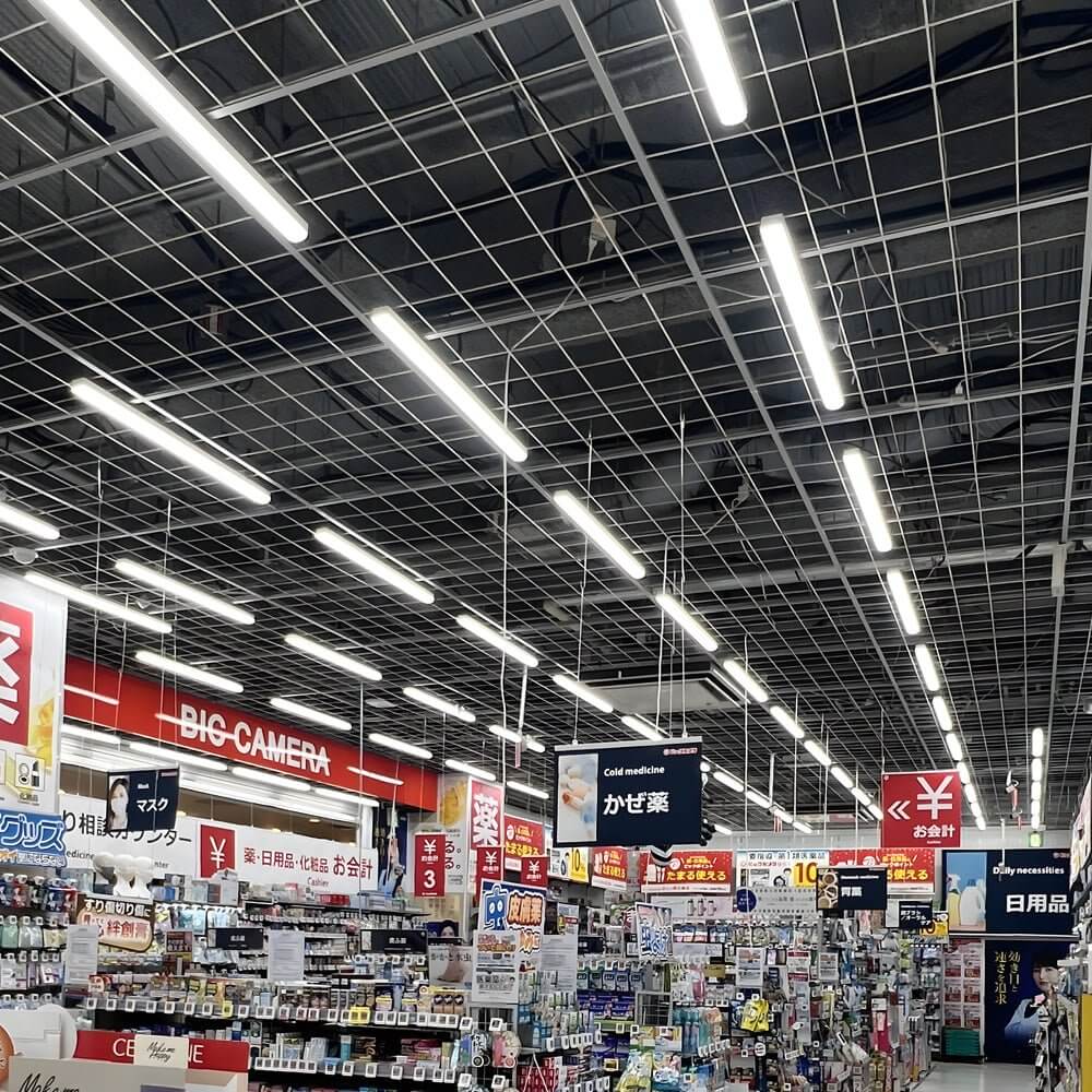 Industrial linear lighting providing bright illumination in a large retail store.