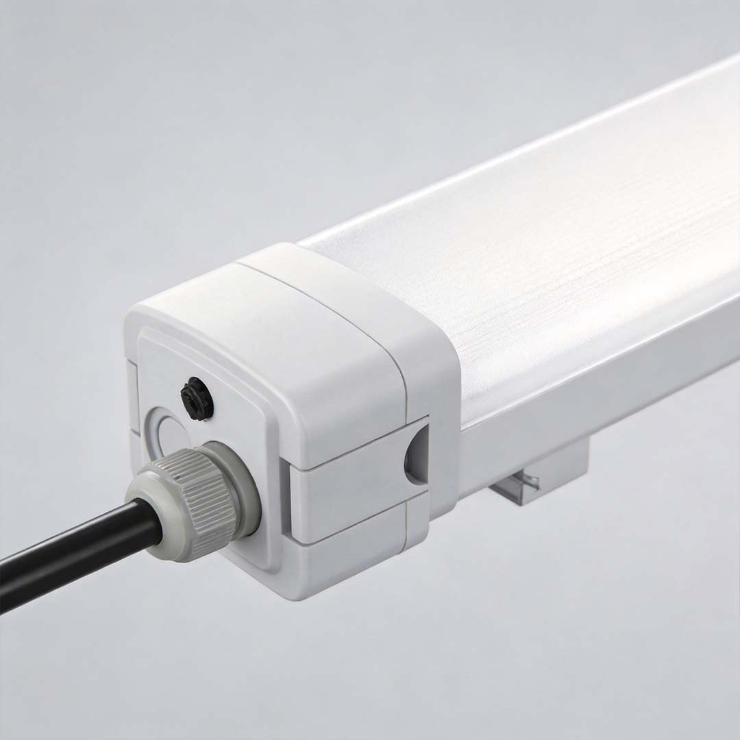 Close-up of industrial linear lighting fixture with white housing and connectors.