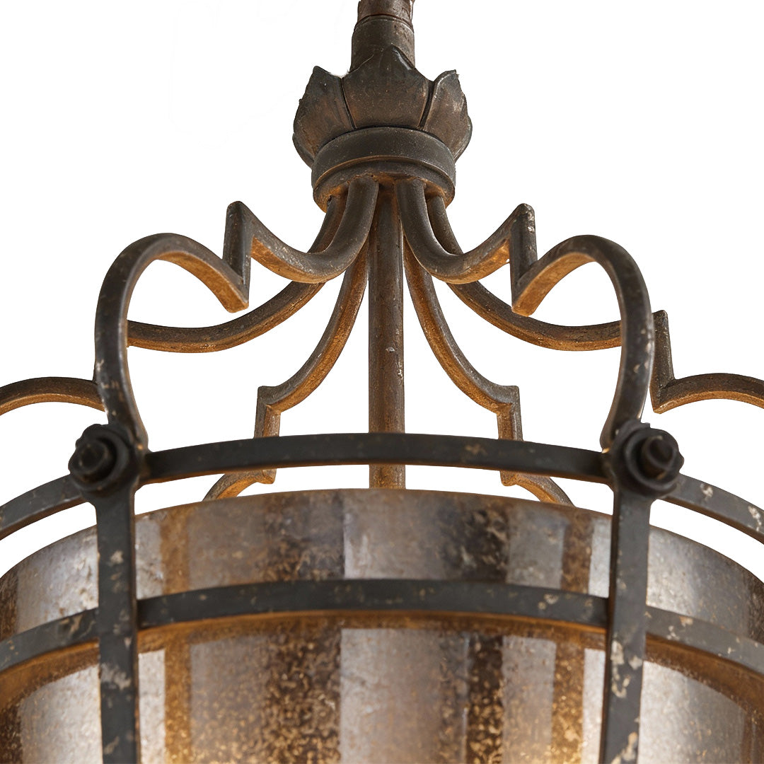 Close up of an Italian pendant light showcasing intricate bronze crown detailing and elegant glass design.