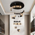 Large K9 crystal chandelier installed above a staircase in modern home.
