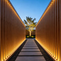 Landscape flood light illuminating modern building facade with warm architectural LED lighting effect.