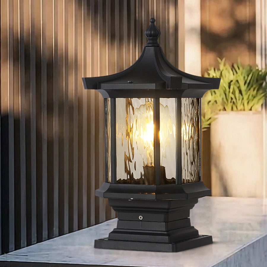 Lantern pillar lights with a black metal frame, providing elegant illumination for a driveway.