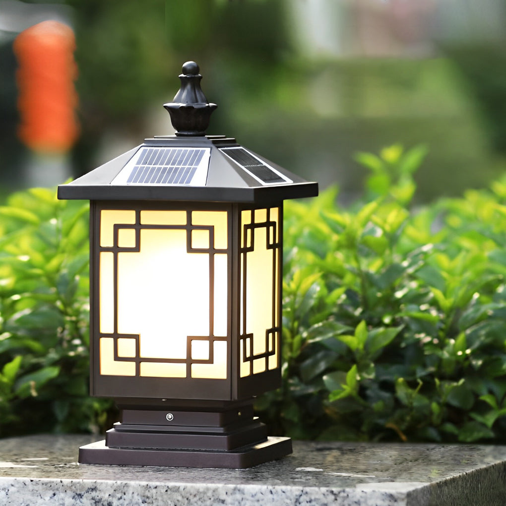 Lantern pillar lights featuring solar top panel displayed in a landscaped outdoor setting.