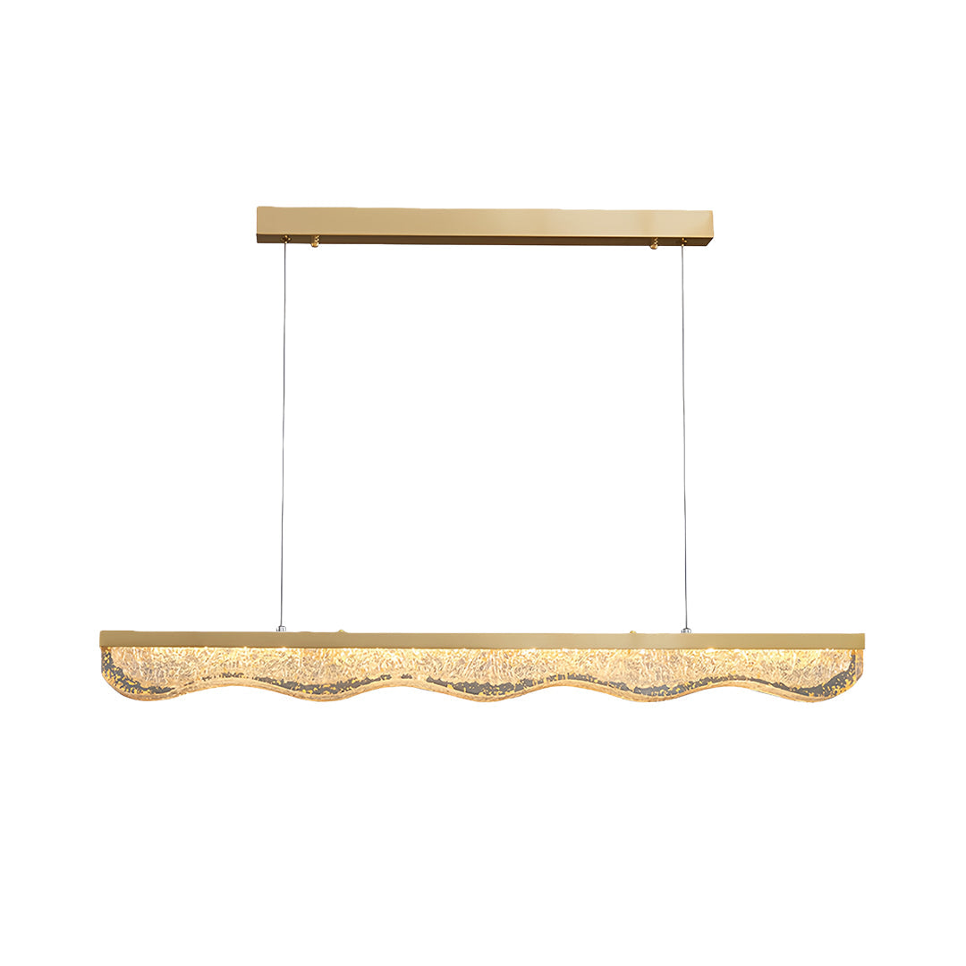Large gold pendant light with textured crystal glass base suspended by three cables on white background.