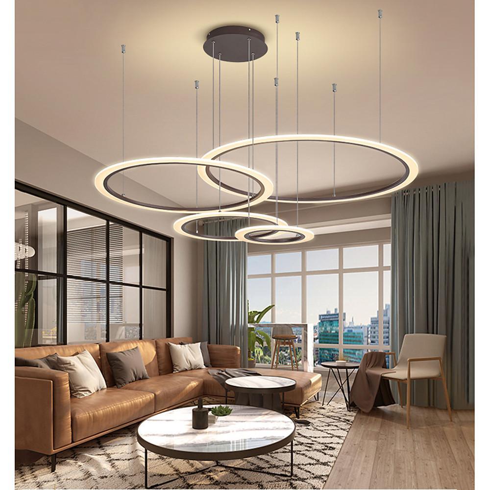 Large multi ring chandelier suspended above a modern apartment seating area.