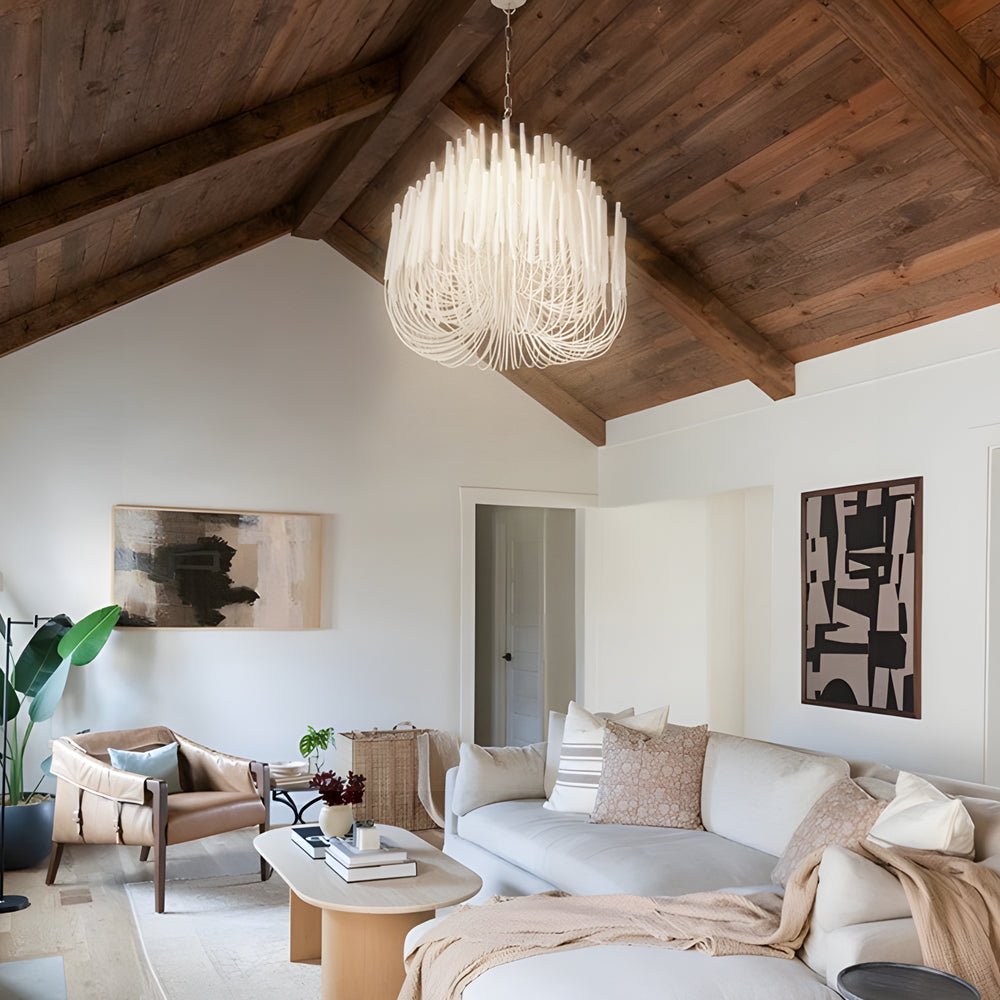 Large organic stick chandelier in a rustic living room, providing a striking focal point with its natural light.