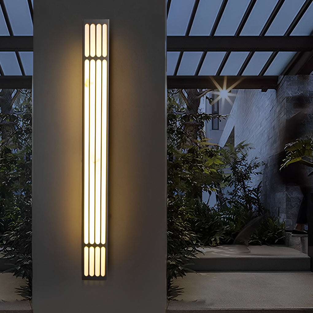 Large outdoor wall light casting a bright glow near a brick wall.