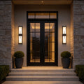 Large outdoor wall light fixtures with sleek black frame, illuminating a modern house entrance.