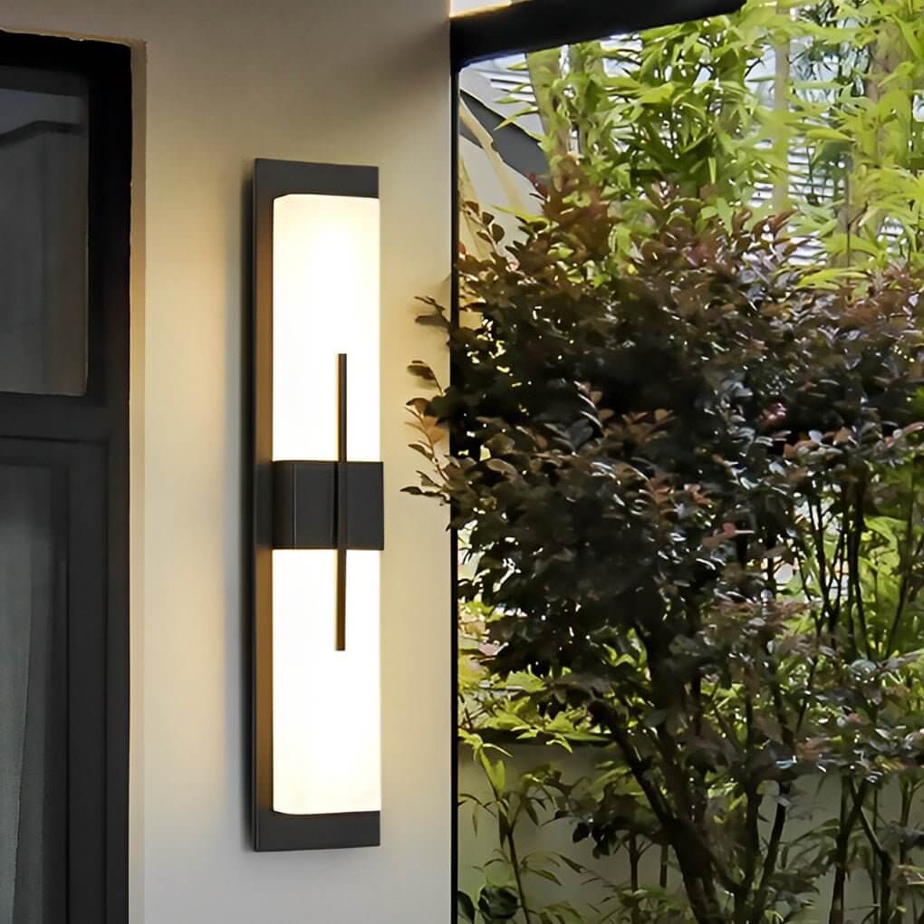 Large outdoor wall light fixtures with vertical light bars, illuminating a modern building facade.