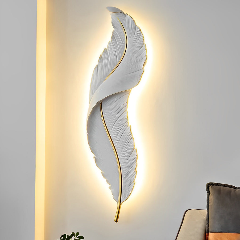 Large white feather wall light emitting warm glow on minimalist interior wall.