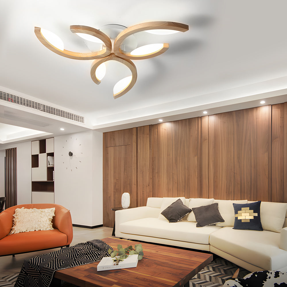 Stylish living space enhanced by a gold-toned leaf ceiling light, blending natural form with modern lighting design.