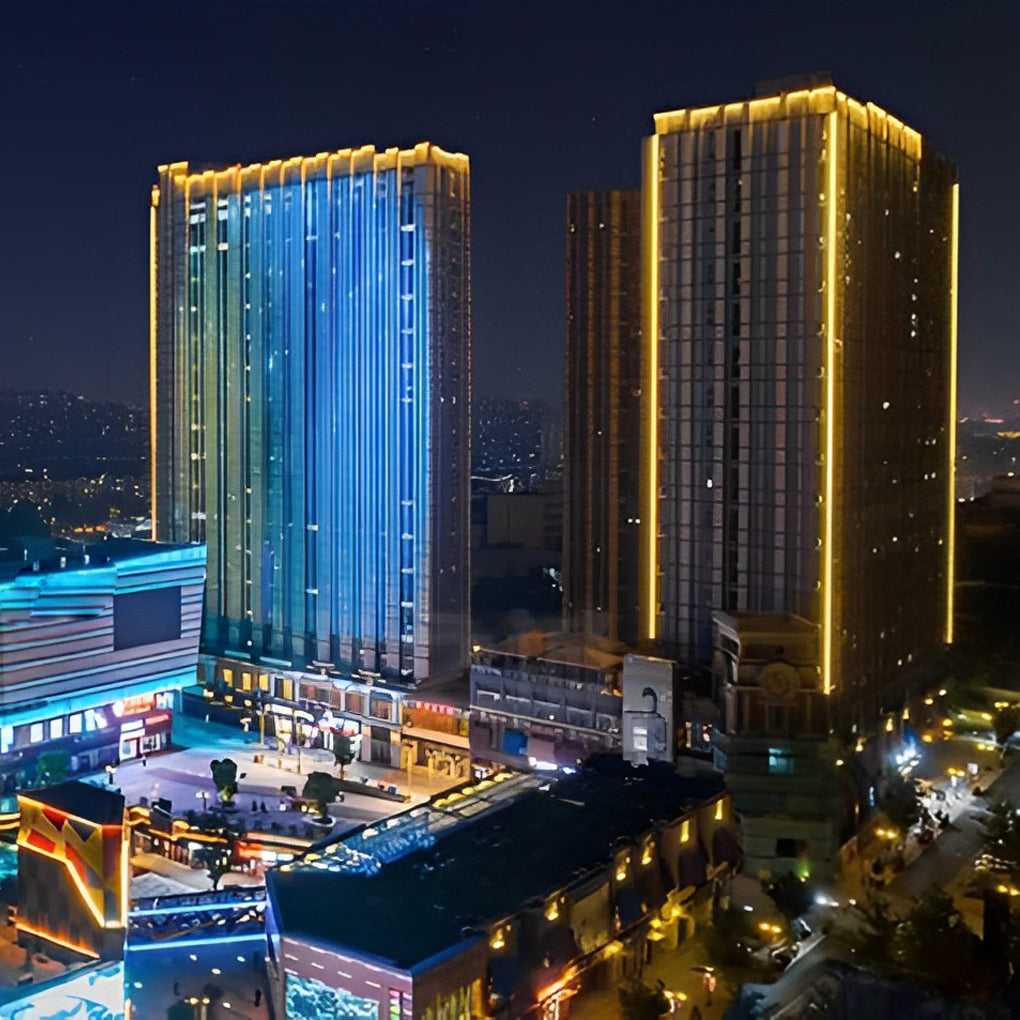City skyline illuminated by LED building facade lighting showcasing vibrant urban architecture at night.