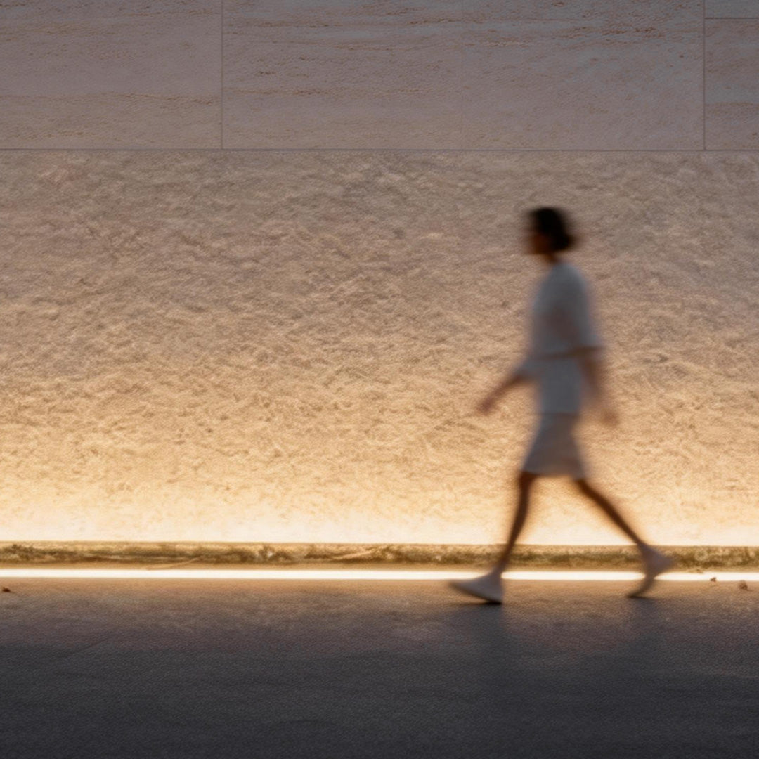 LED building facade lighting casting a soft glow along a pathway for safe and stylish pedestrian walkway.