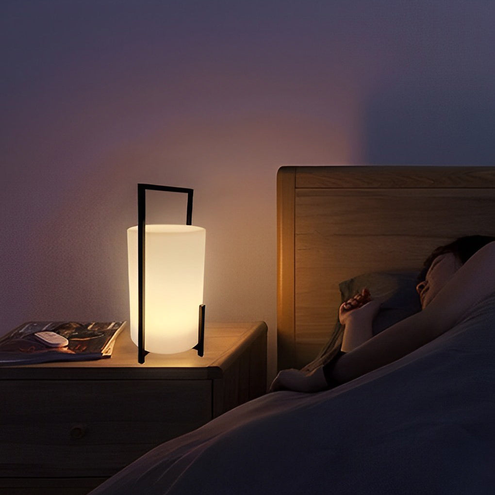 LED cylinder light fixture providing soft light in a cozy bedroom setting.