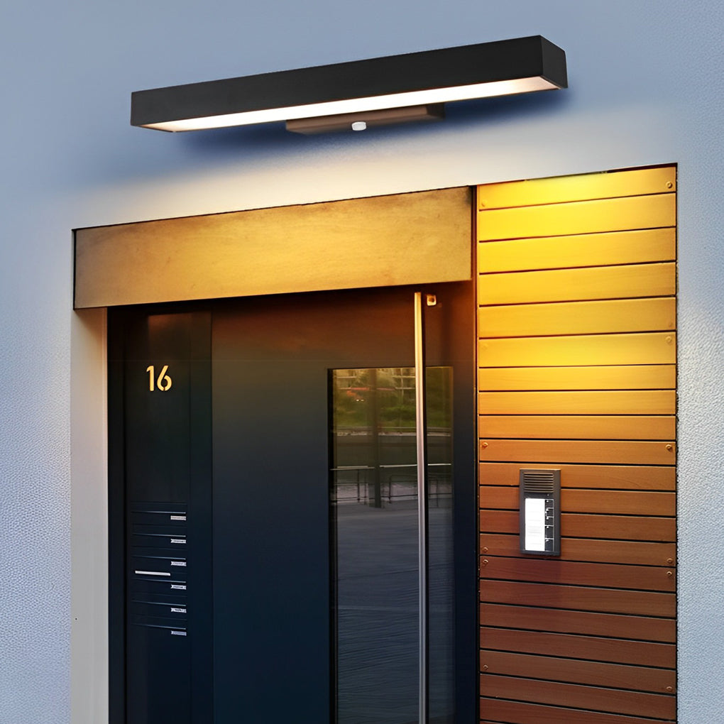 Modern LED linear wall light mounted above a contemporary door with house number detail, offering functional and stylish lighting.