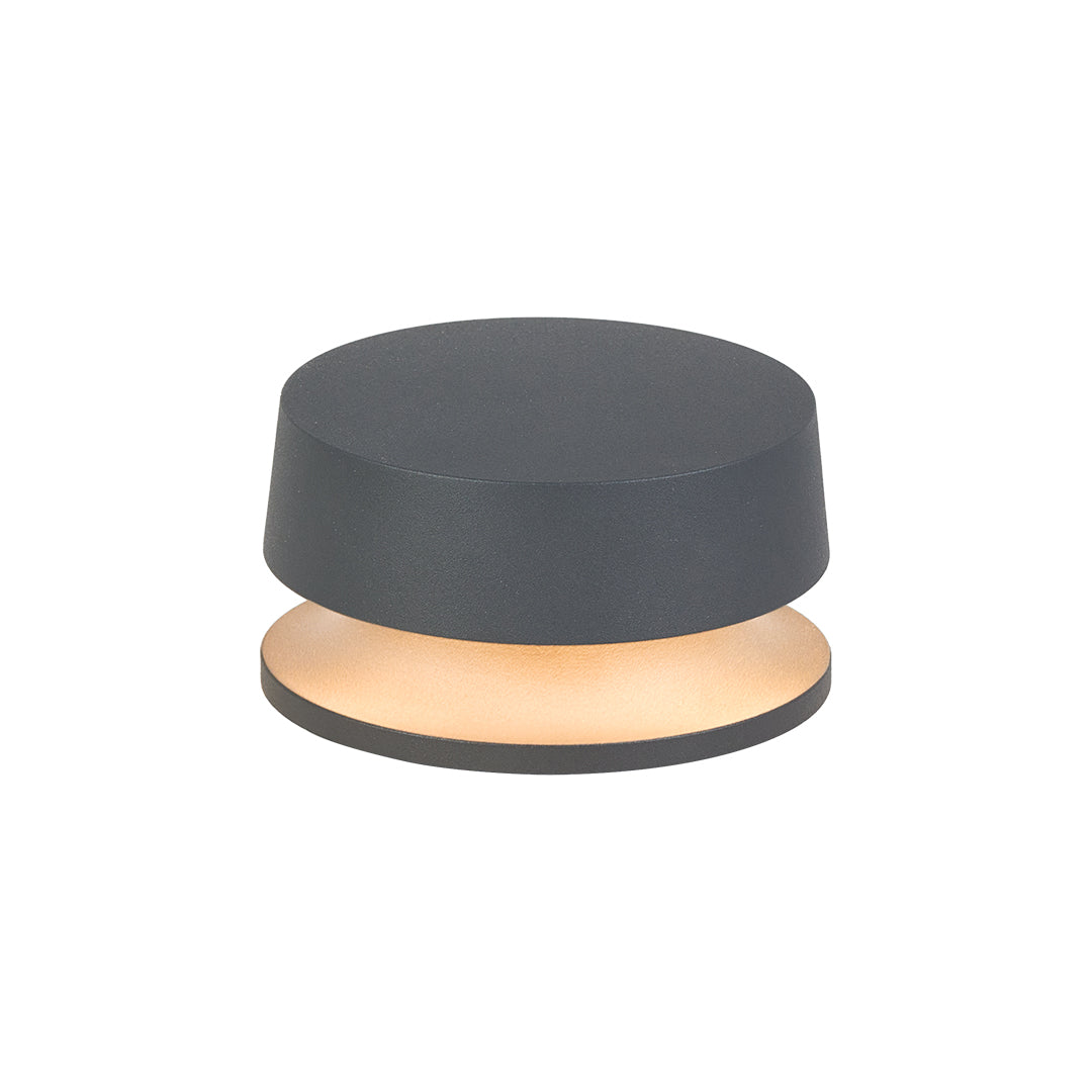 Studio shot of a low-profile LED outdoor landscape lights emitting soft ambient light from beneath the fixture.