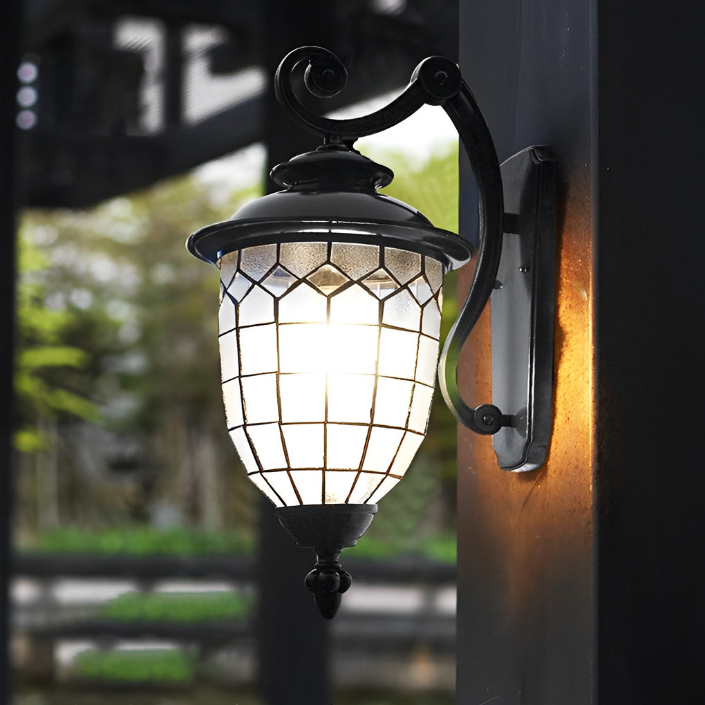 Traditional LED outdoor sconce with clear glass shade mounted on exterior wall.