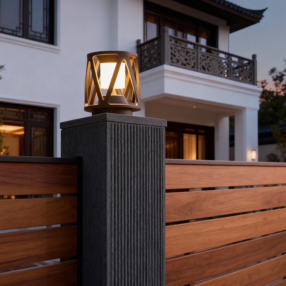 Modern led pillar light installed on a concrete post beside a contemporary house, lighting the outdoor walkway area.