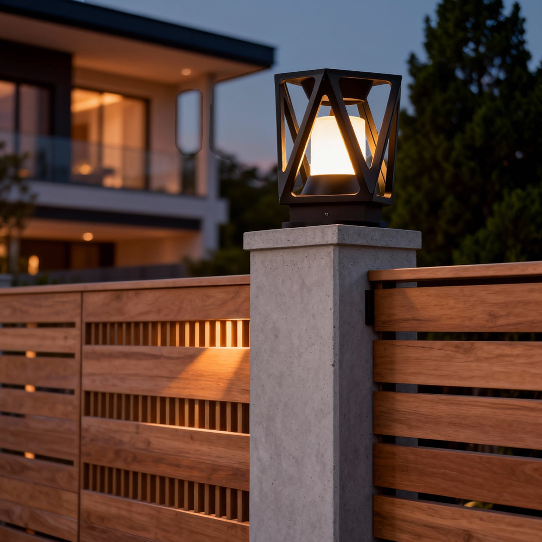 Outdoor led pillar light positioned on a stone pillar next to a wooden fence, highlighting the warm architectural lighting design.