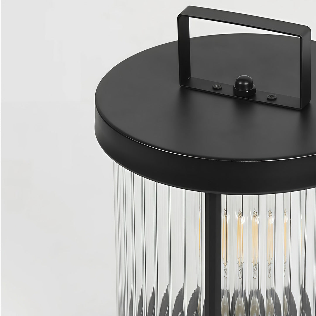 Close up of an LED solar lanterns outdoor, showcasing its clear glass design and warm light.