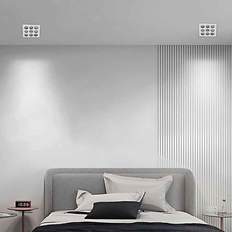 LED spotlights bulbs highlighting a framed artwork on a gray wall.