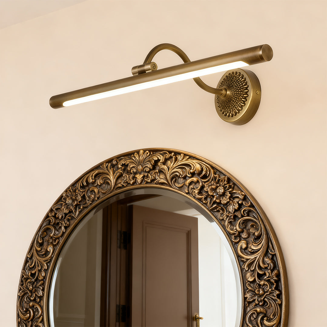 LED vanity bathroom lights in brass finish, installed above a bathroom mirror for focused lighting.