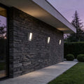 LED wall light outdoor waterproof illuminating a modern house exterior at dusk.