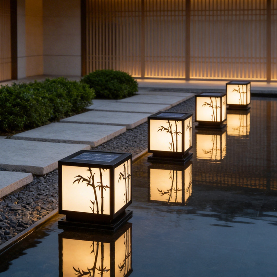 Light box pillar lights enhancing a contemporary pathway with soft bamboo-patterned glow.