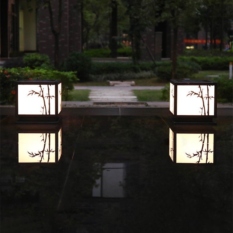 Light box pillar lights providing soft light in a cozy garden corner.