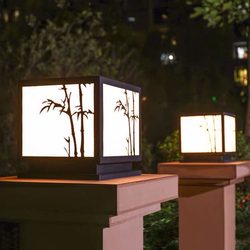 Light box pillar lights providing ambient light along a landscaped garden walkway.