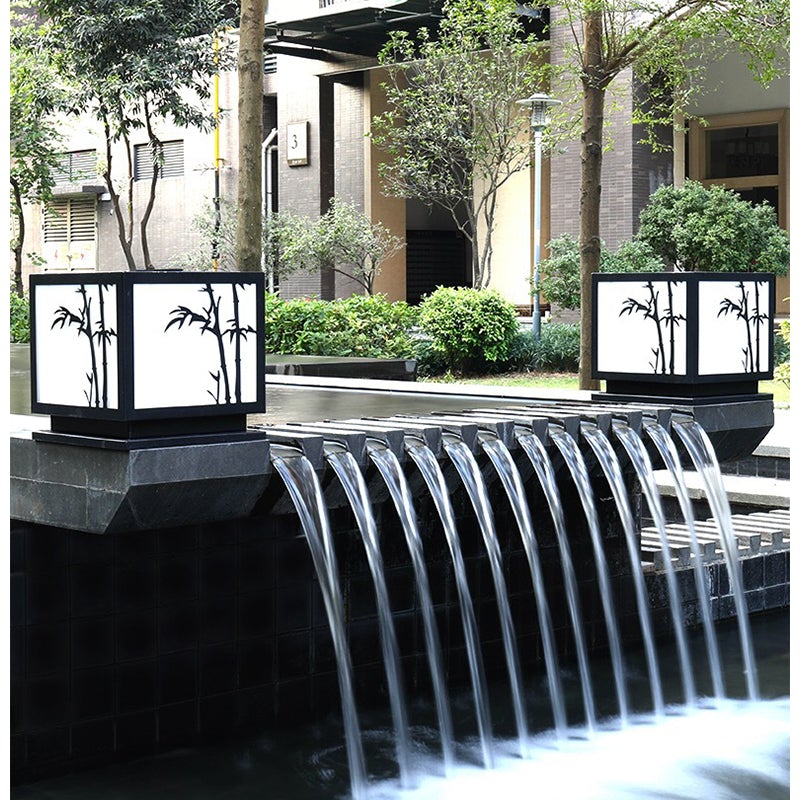 Light box pillar lights enhancing a modern patio with elegant bamboo glow.
