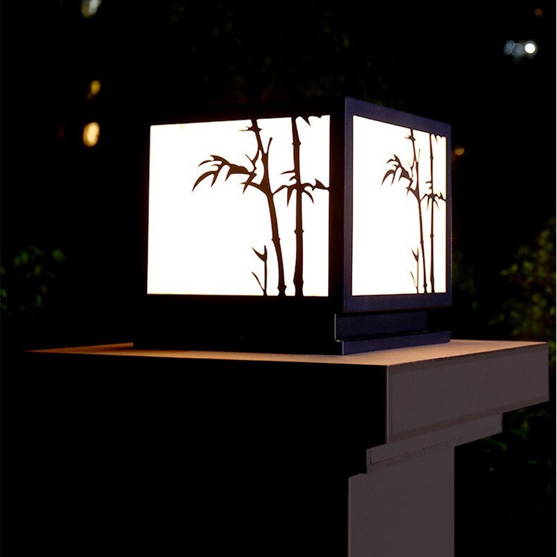 Light box pillar lights illuminating a water feature with warm bamboo light.