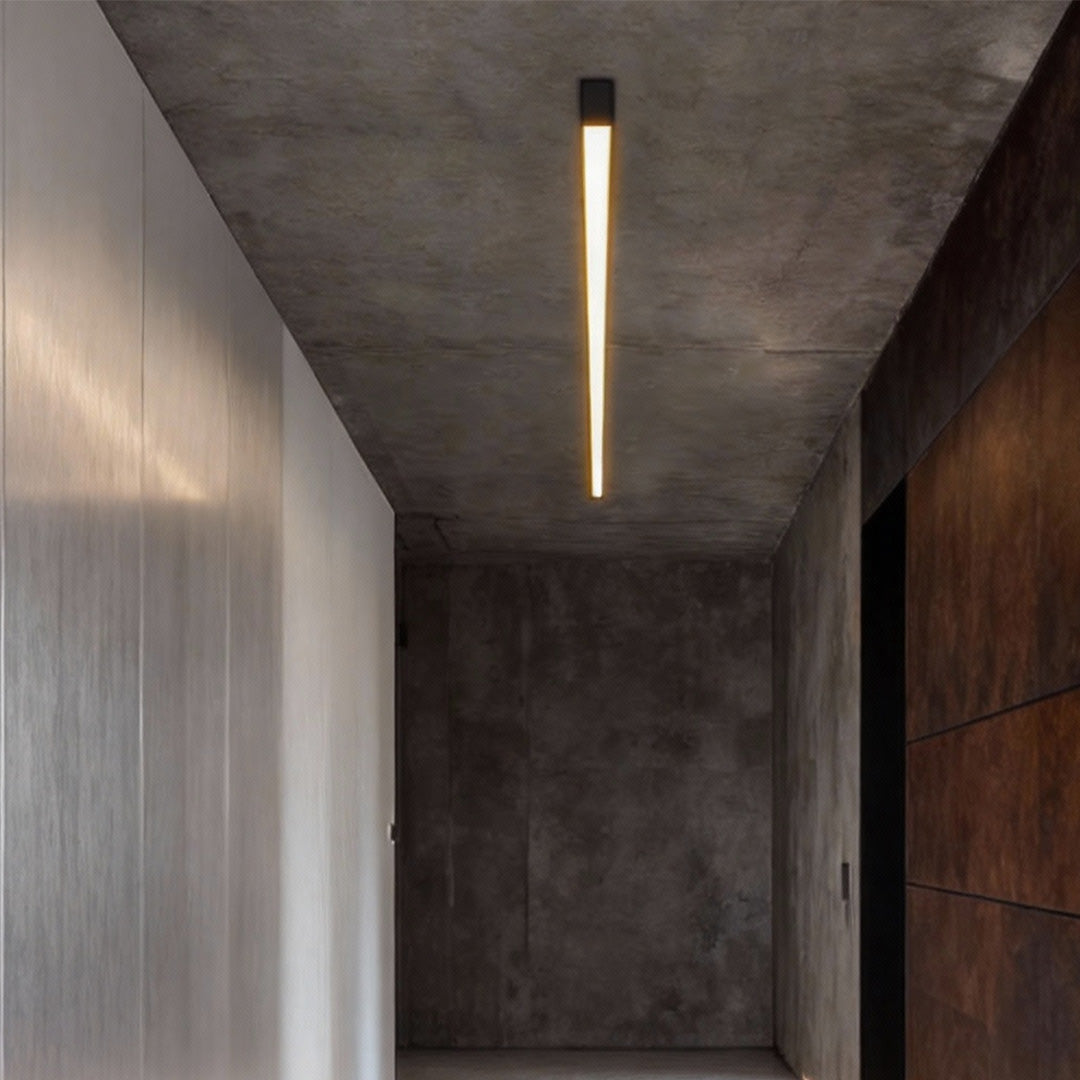 Slim linear ceiling light illuminating a narrow hallway with modern design.