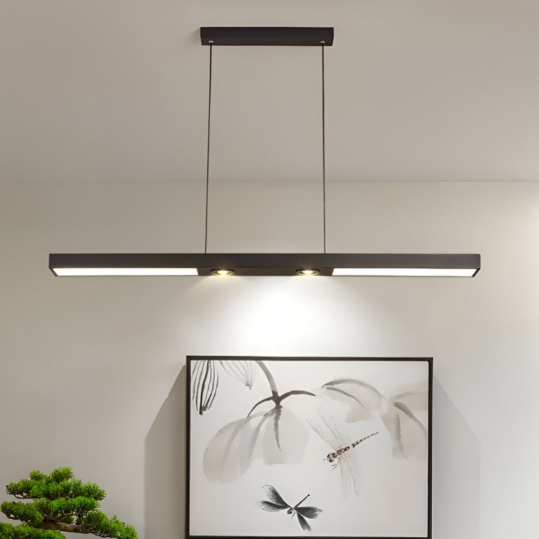 Linear ceiling pendant light hanging above dining table