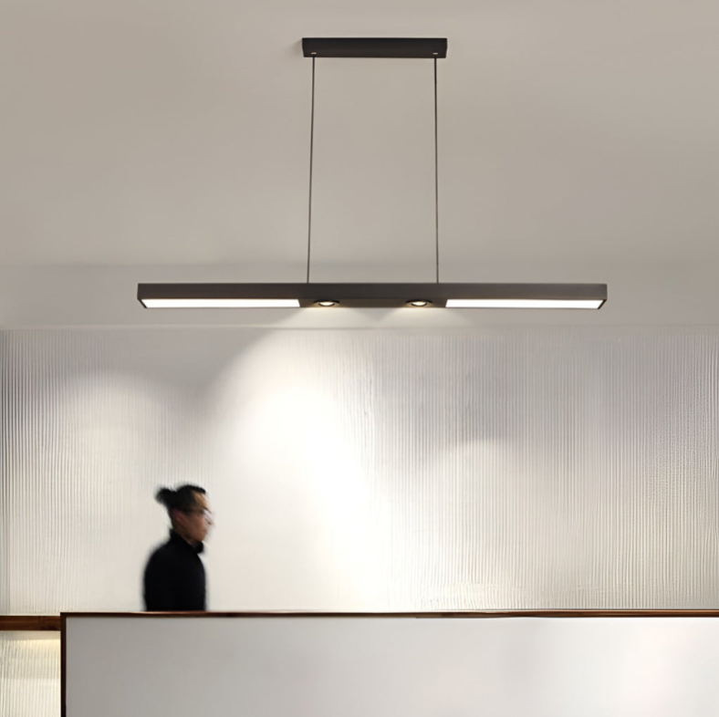 Linear ceiling pendant light above front desk counter