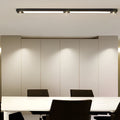 Linear ceiling pendant light installed in modern office workspace