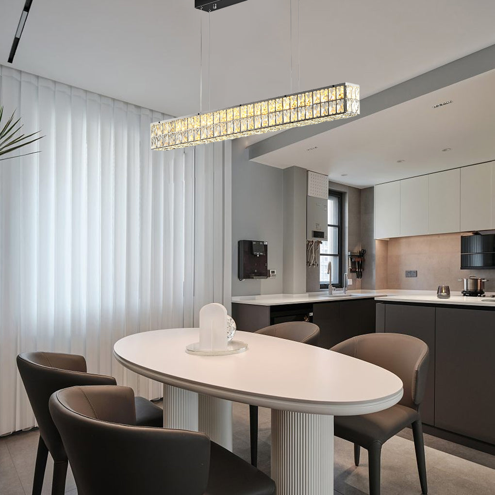 Linear crystal light fixture hanging above a white oval dining table in a stylish dining room.