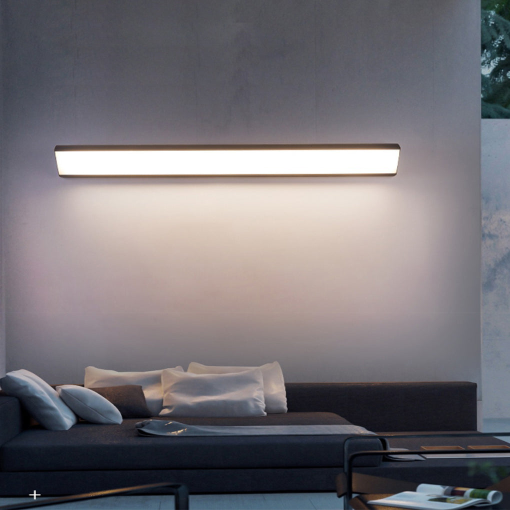 Linear exterior wall sconce creating ambient lighting on a minimalist outdoor wall.
